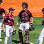 Little Rock baseball team celebrates with bus driver on the field after upset win to advance to Super Regional